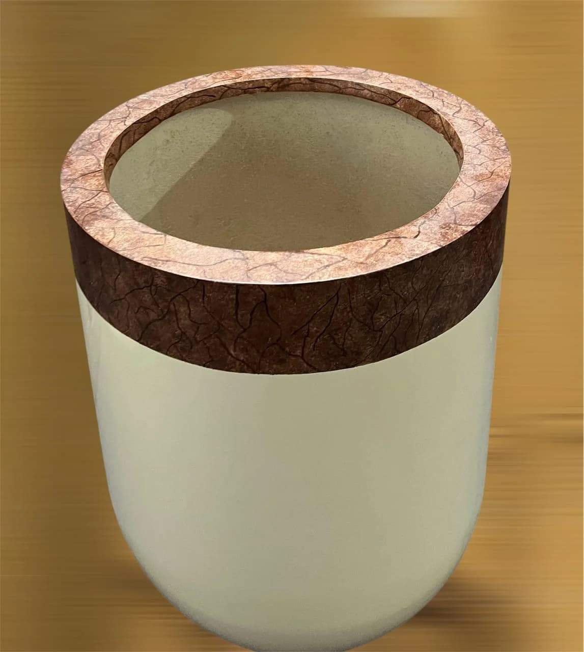 Cream planter with a brown textured rim