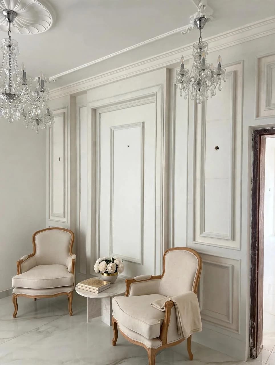 White decorative wall panelling with cornice and a ceiling rose