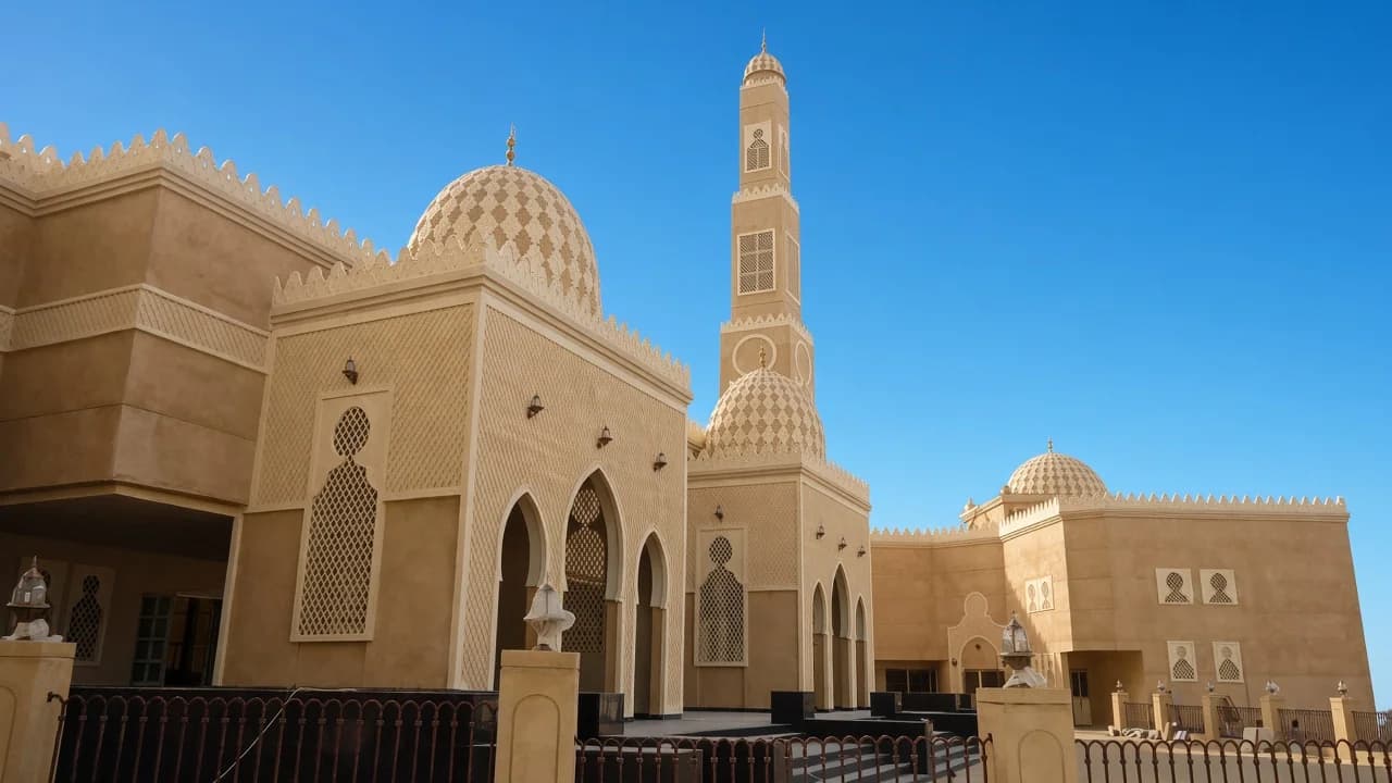 Mosque exterior with patterned domes, a minaret, and lattice screens